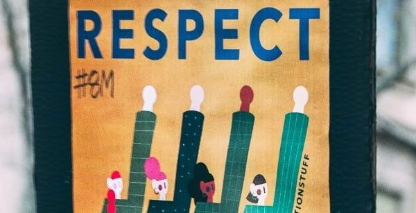 Protest poster of 4 people raising their arms in the air. The word RESPECT is written above the painted image of the 4 people.